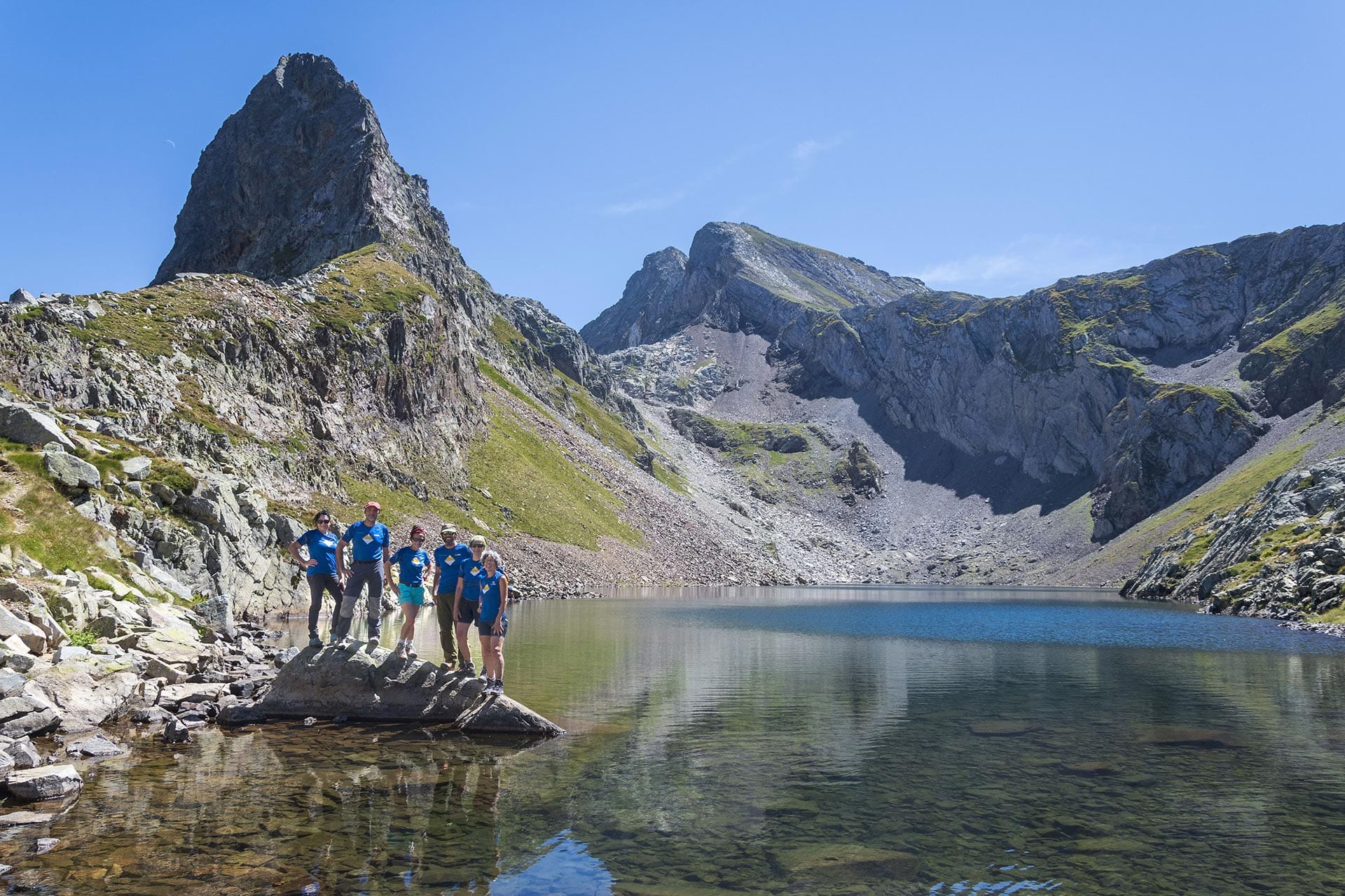 Lac d'Arrious con montañeros haciendo el trkking de 3000 ibones con guía de montaña